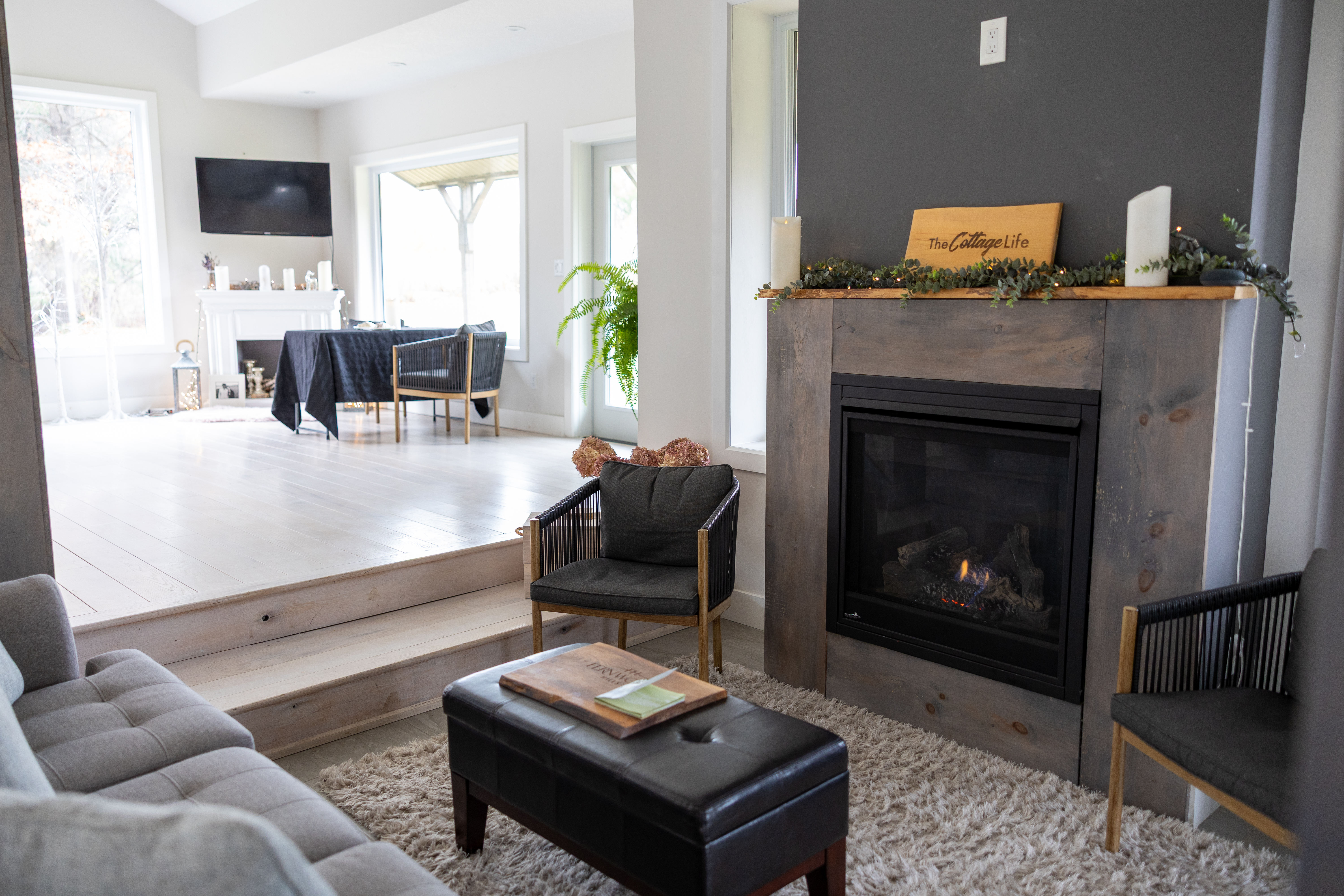 Cozy lounge with fireplace, sunlit dining nook, and modern comforts